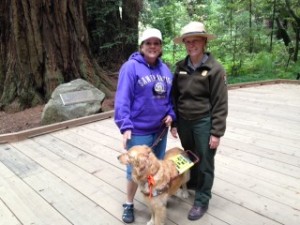 Ranger Lucy in uniform standing with me and my guide dog